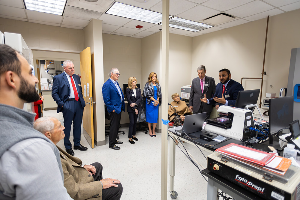 Man giving a tour to a group of individuals in a hospital