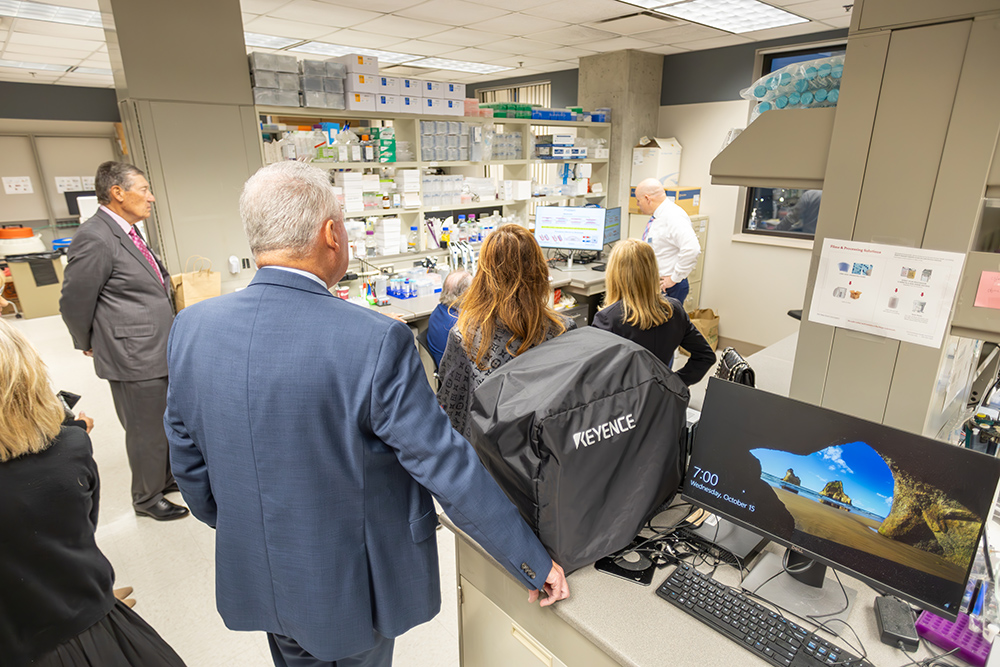 Man giving a tour to a group of individuals in a hospital