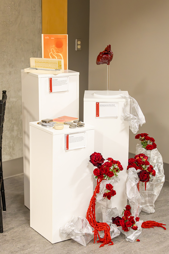 White pillars on display with red flower arrangements