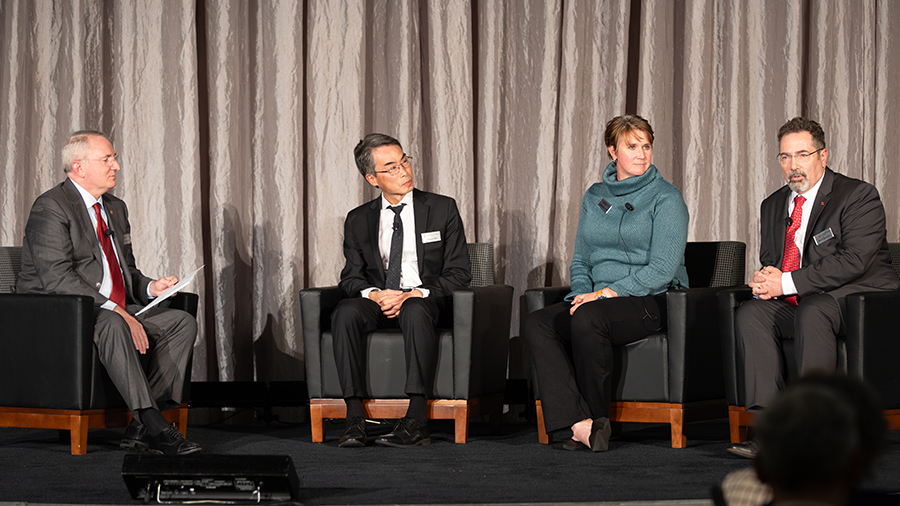 Dr. Wu with other panel members on stage.