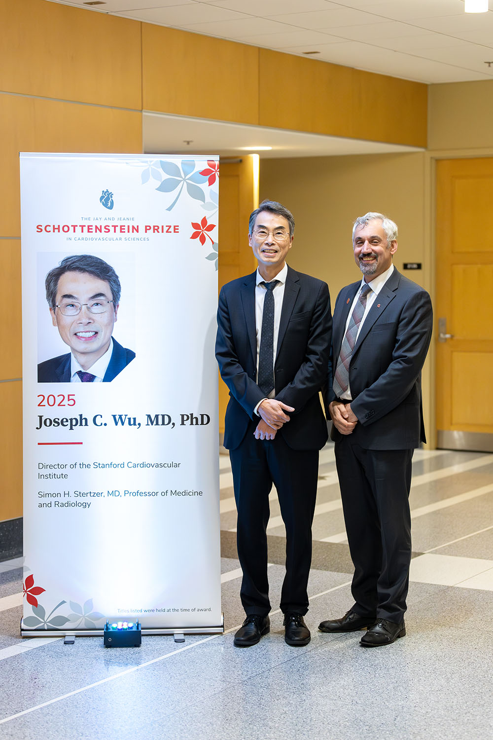 Dr. Tom Hund and Dr. Joe Wu standing next to a popup banner.