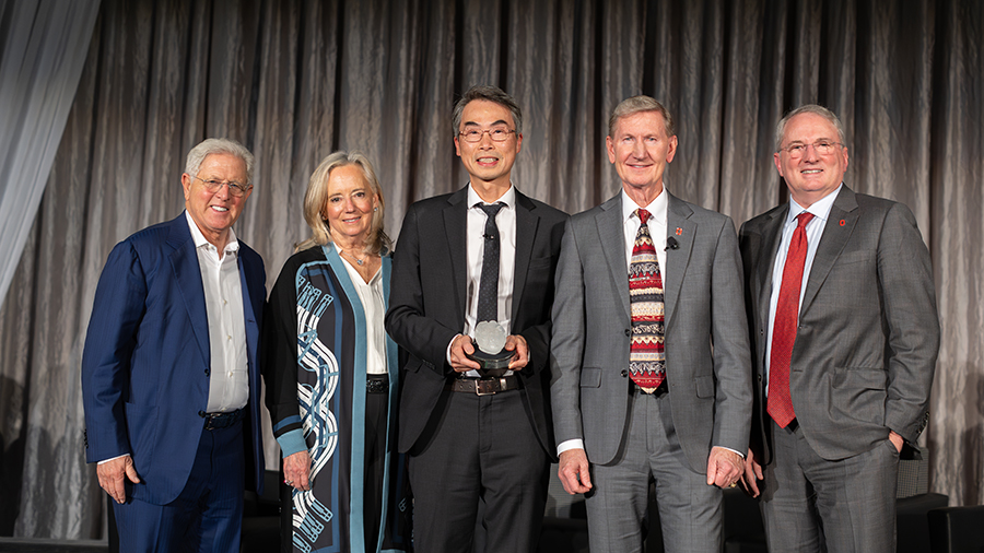 Dr. Wu with President Carter and others posing for a photo with the award.
