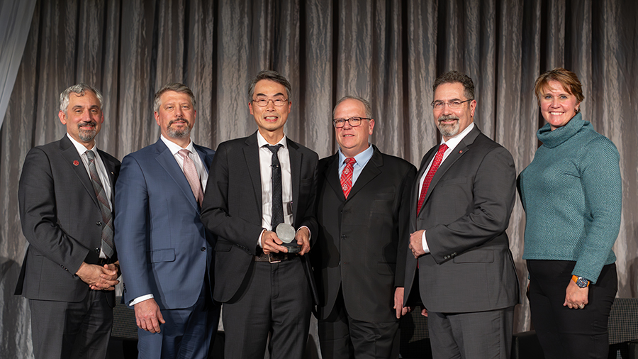 Dr. Wu and others posing for a photo with the award.