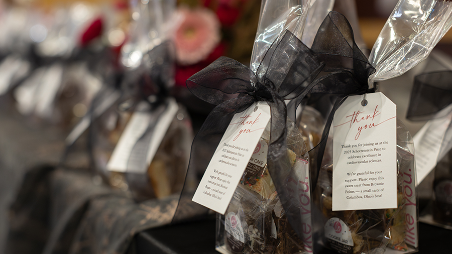 Desserts wrapped in a silver bag with a thank you tag.