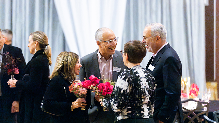 Guests mingling and talking in the event room.