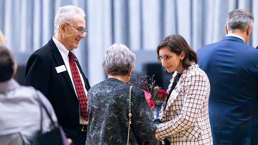 Guests mingling and talking in the event room.