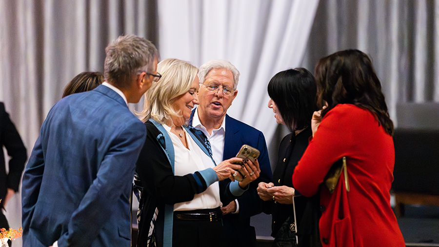 Guests mingling and talking in the event room.