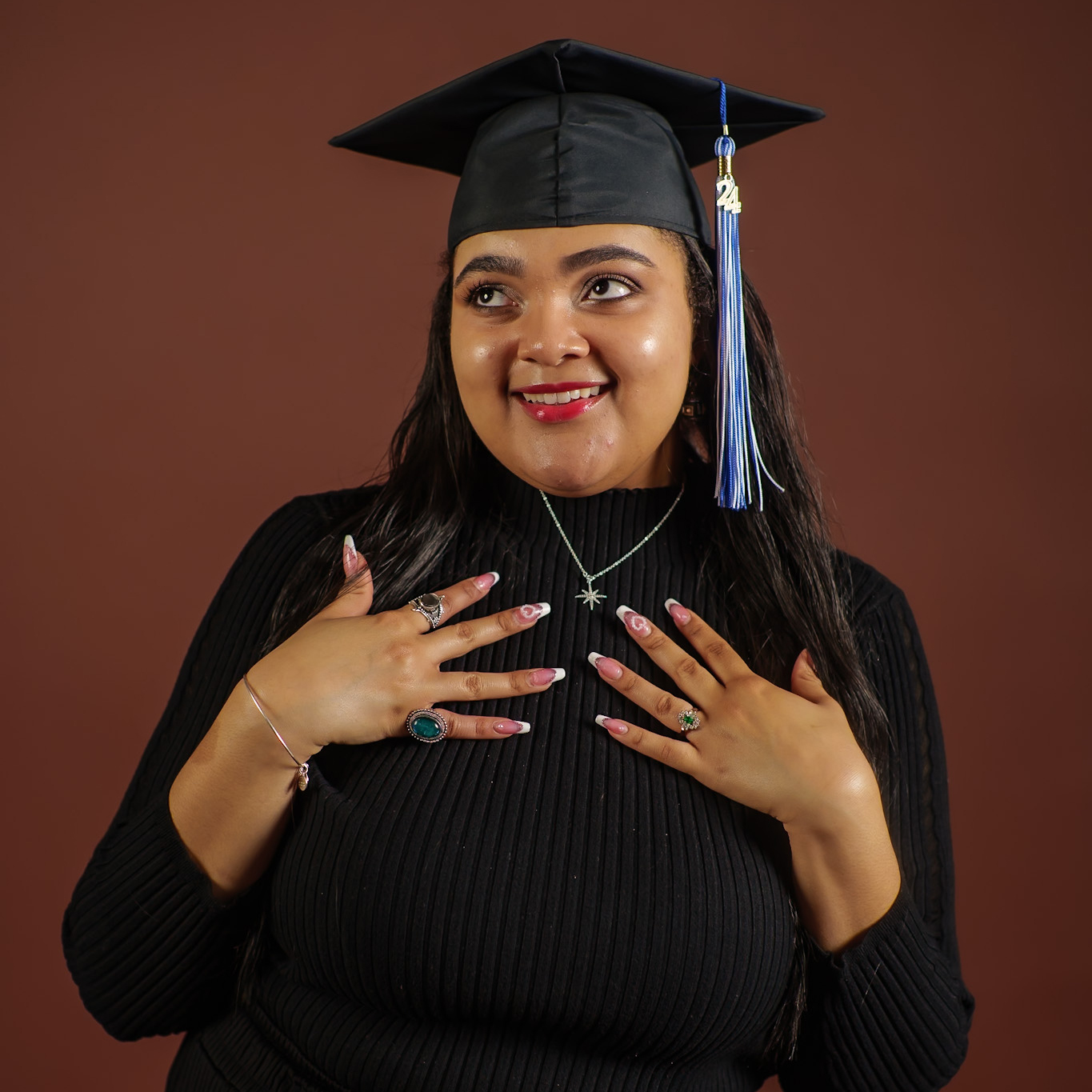 Portrait of Faith wearing wearing a black graduation cap.