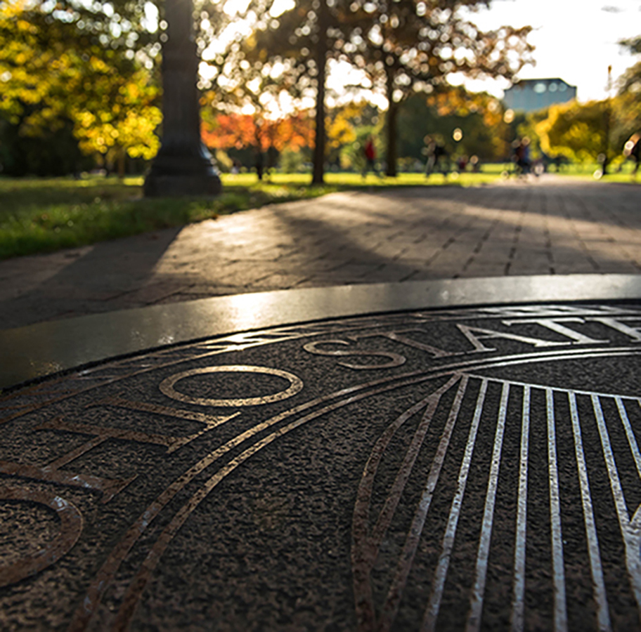 the ohio state university seal on a campus walkway