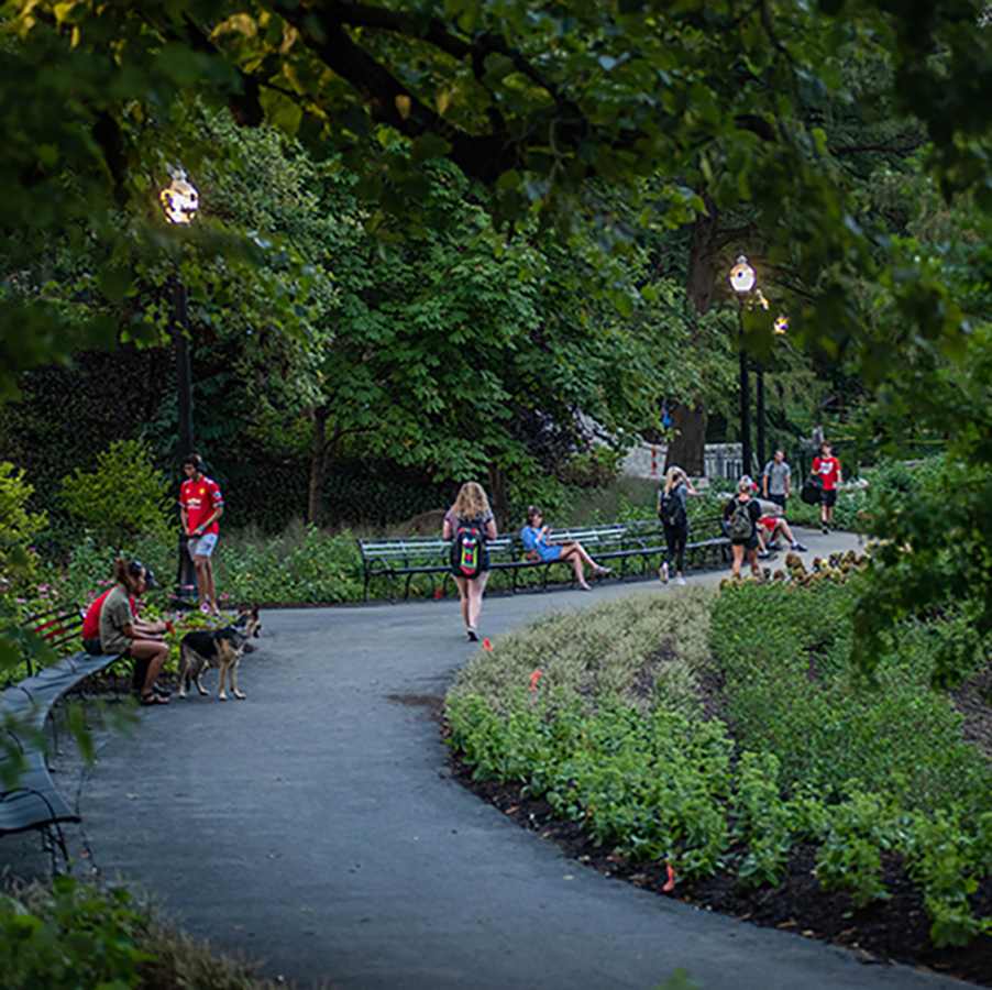 students walking on a path around mirror lake in the evening