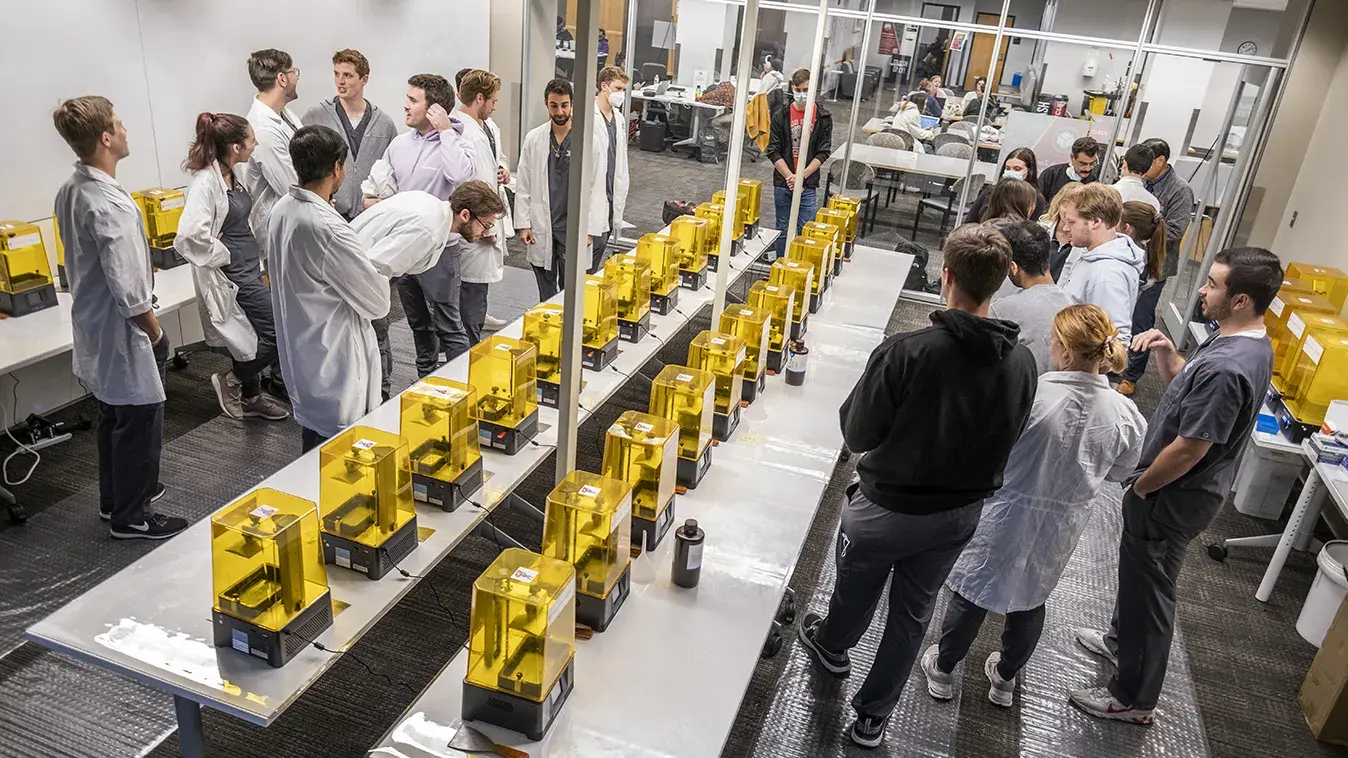 dentistry students watch 3d printers creating new sets of teeth