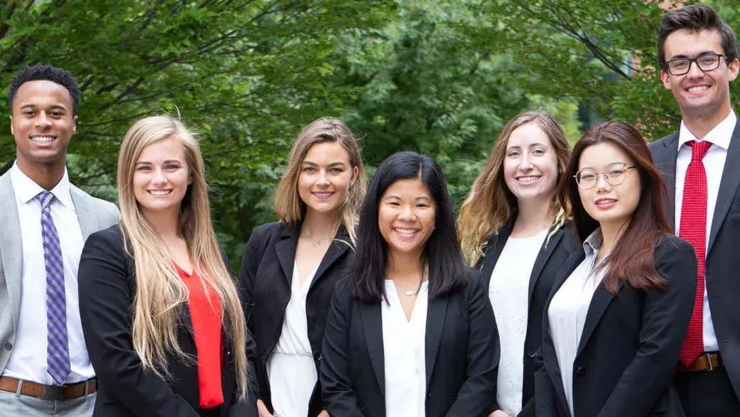 Fischer College of Business students in suits posting for a picture outdoors