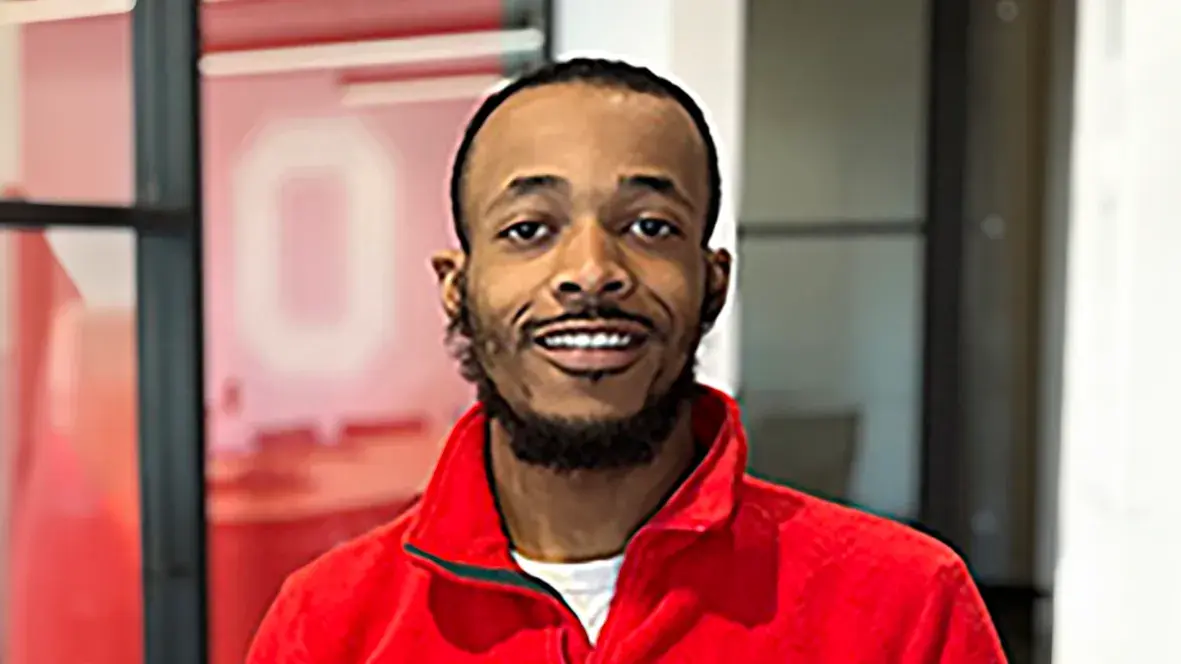 malik davis portrait wearing a red north face fleece zip up