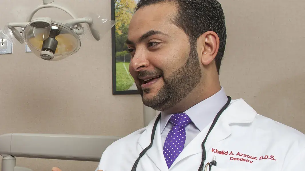 dentist talking with a patient during a dental visit