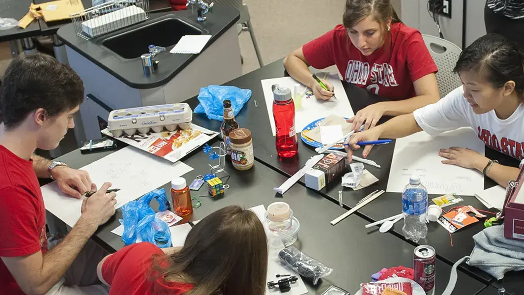 students brainstorming ideas a a large communal table