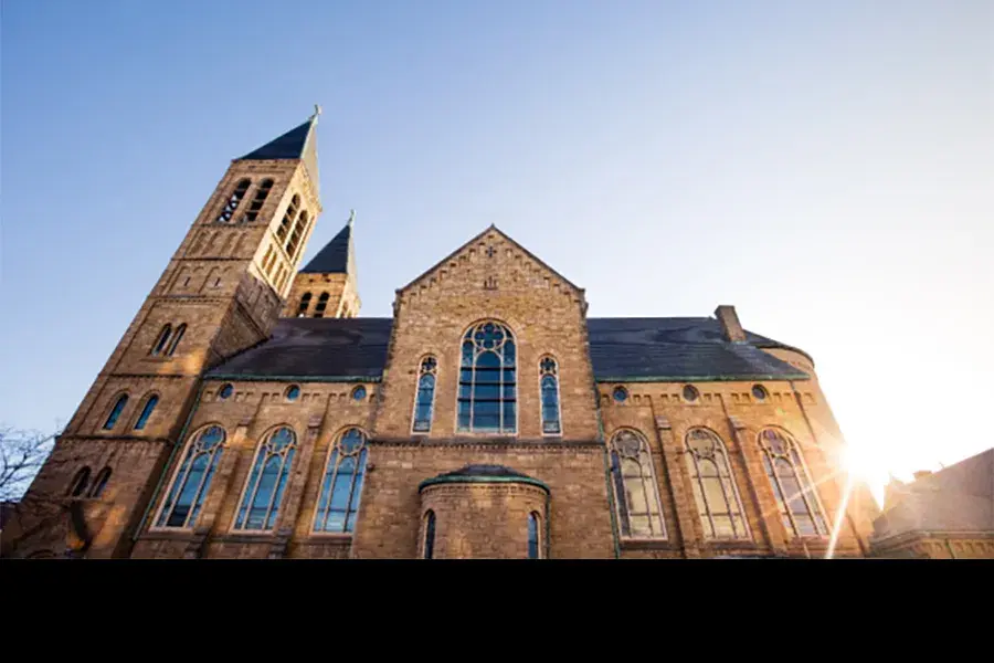 steep angle of a building on OSU's campus with the sun setting behind it