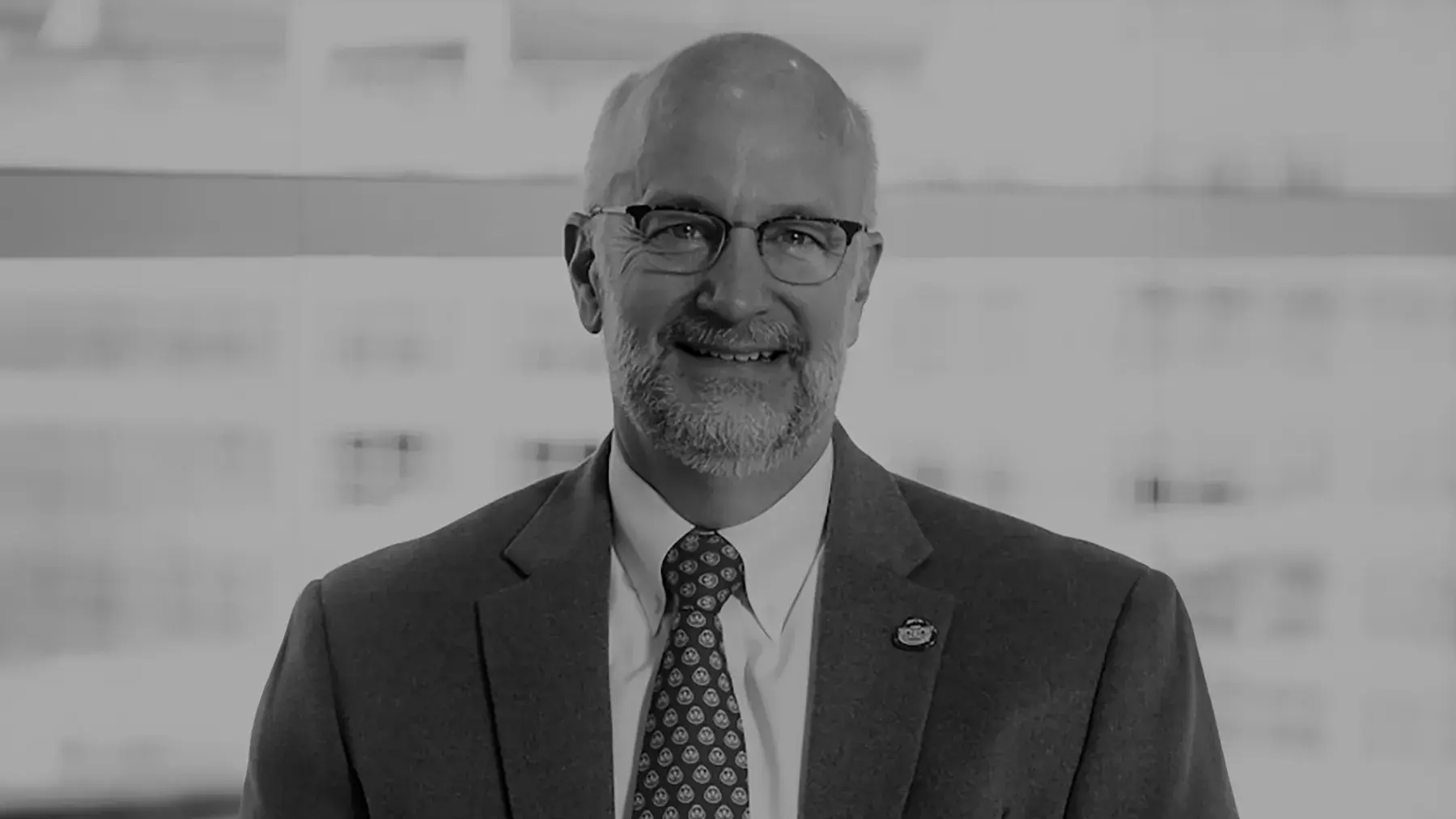 black and white portrait of Donald Mutti, OD, PhD wearing a suit and tie