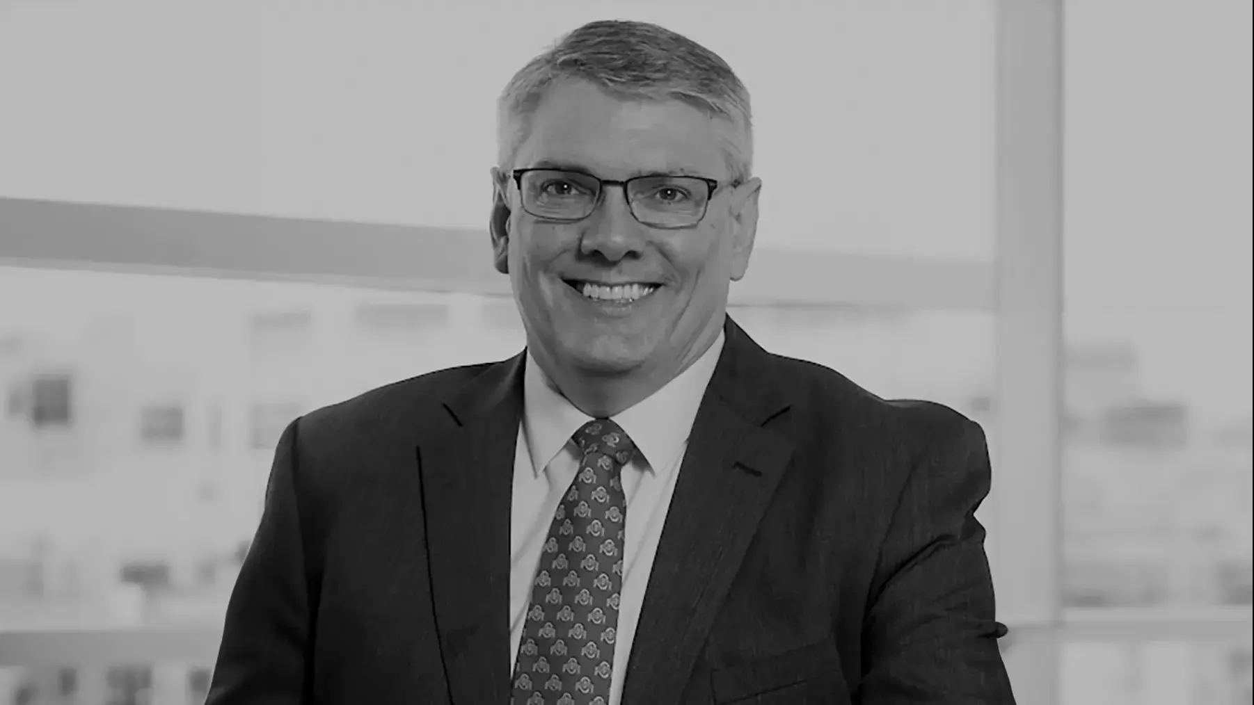 black and white portrait of Michael Earley, OD, PhD wearing a suit and tie