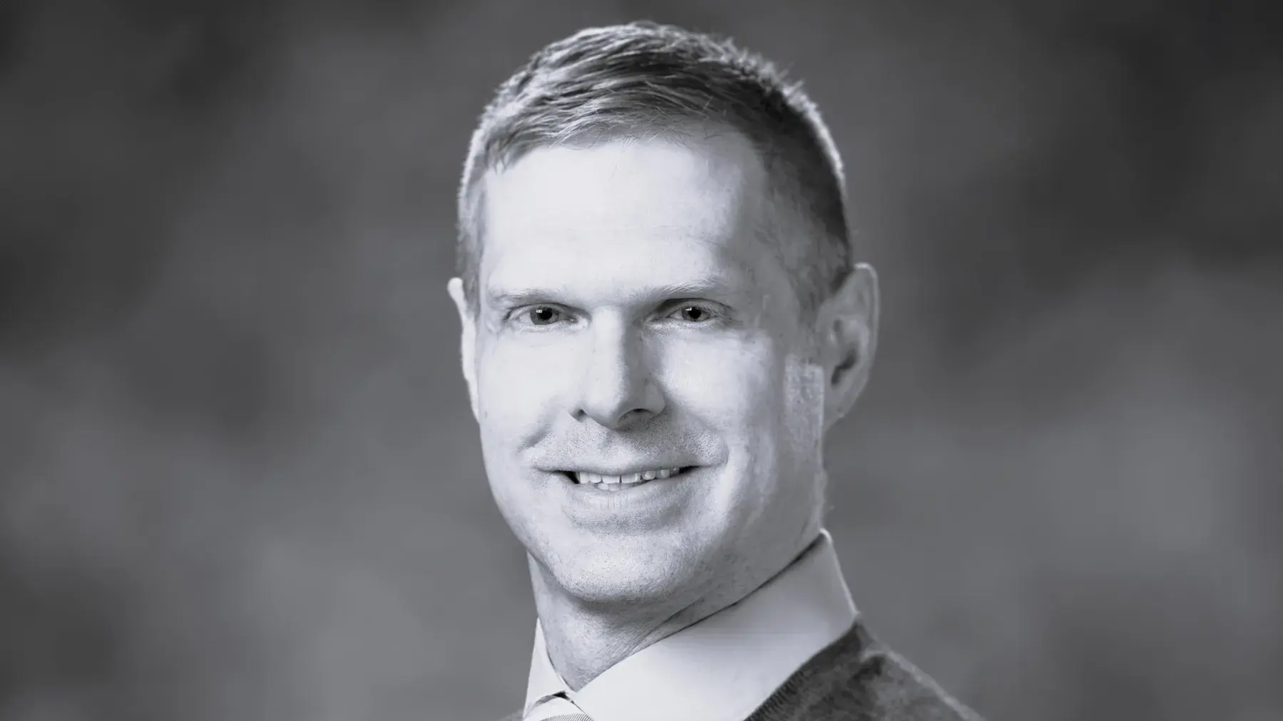 black and white portrait of Eric Green, DVM wearing a suit and tie