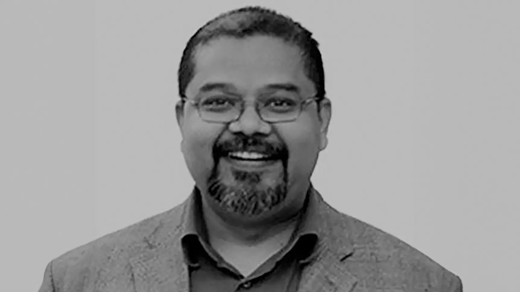 black and white portrait of Russell Hassan, PhD wearing a suit jacket