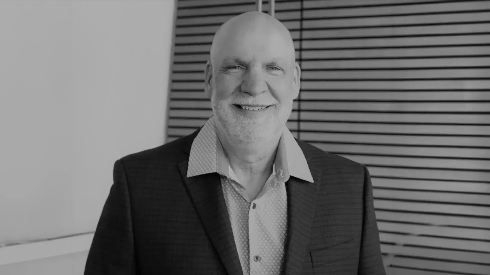 black and white portrait of Jim Landers, PhD in a suit jacket