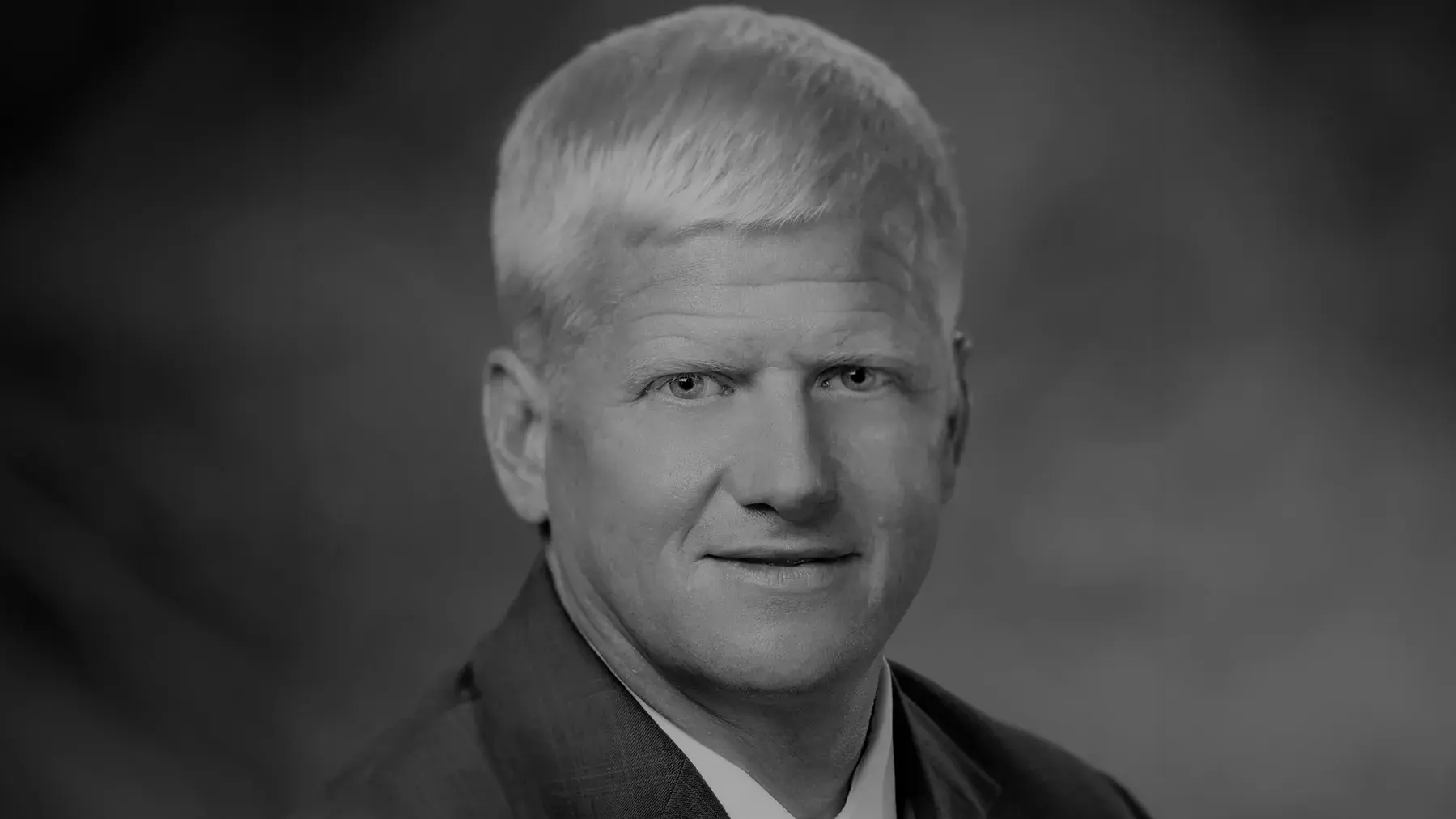 black and white portrait of Rustin M. Moore, DVM wearing a suit and tie