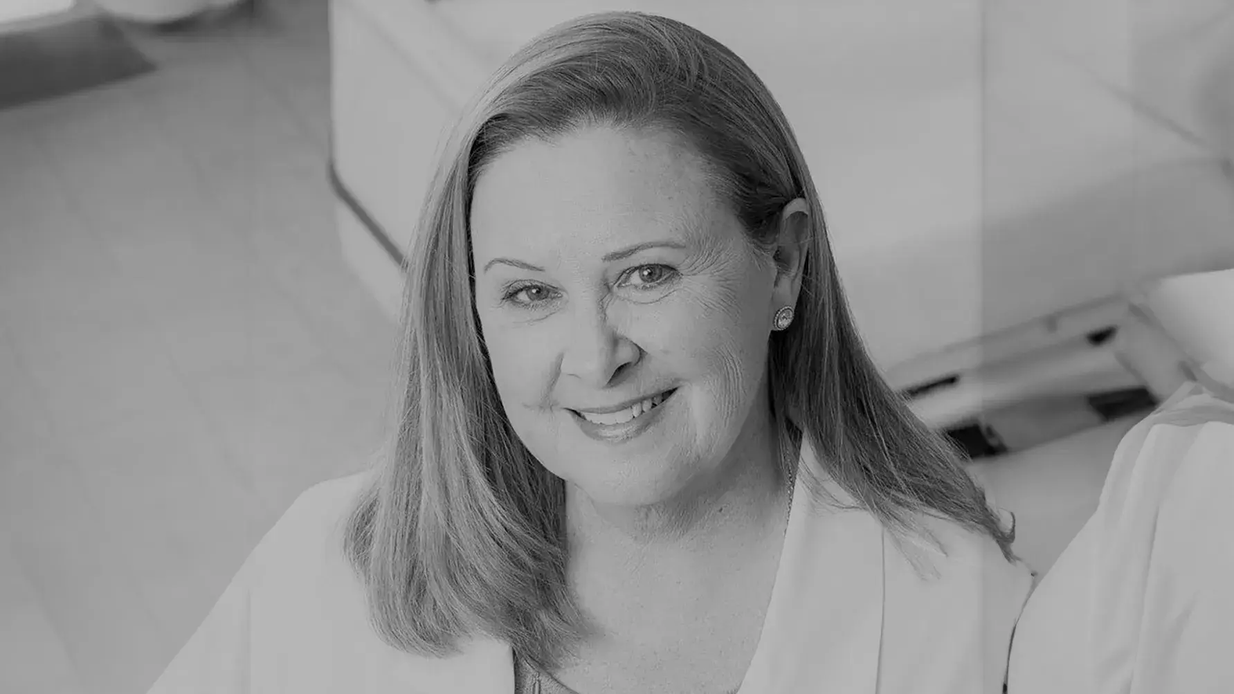 black and white portrait of Rita Pickler, PhD wearing a lab coat in a hospital setting