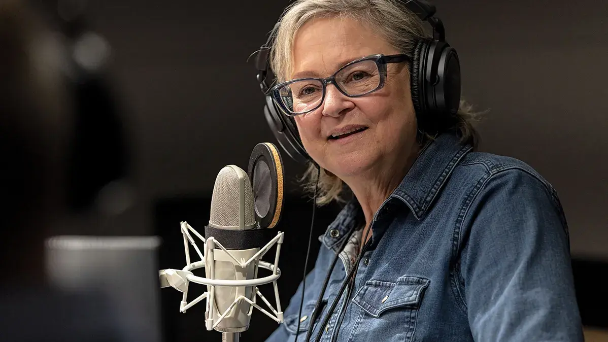 Ann Fisher speaking into microphone