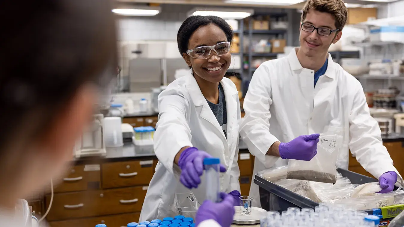 Three students work together in a lab
