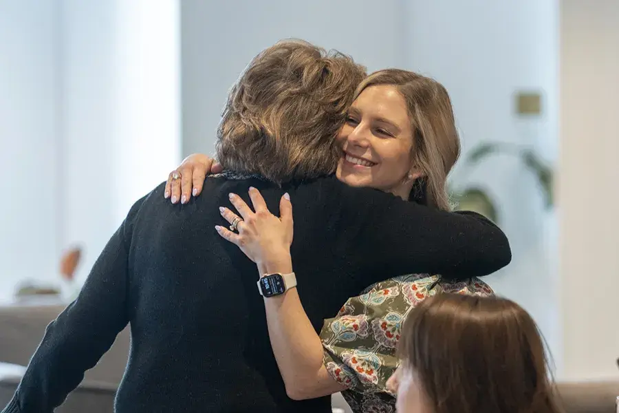 Two women hug