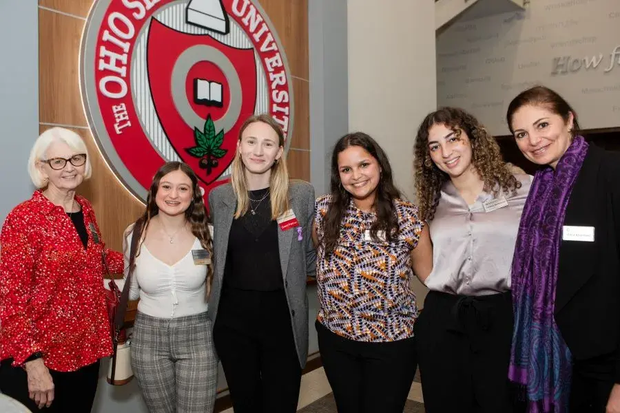 Women & Philanthropy members and scholarship students stand together