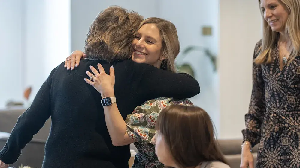 Two women hug