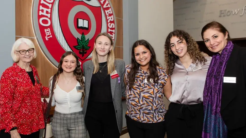 Women & Philanthropy members and scholarship students stand together