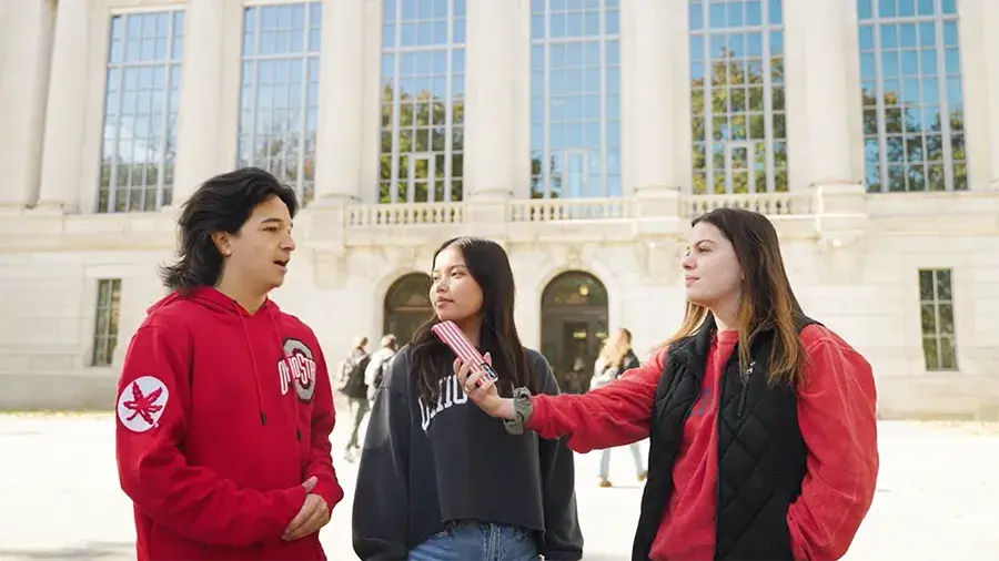 Three students being interview outside the Thompson Library.