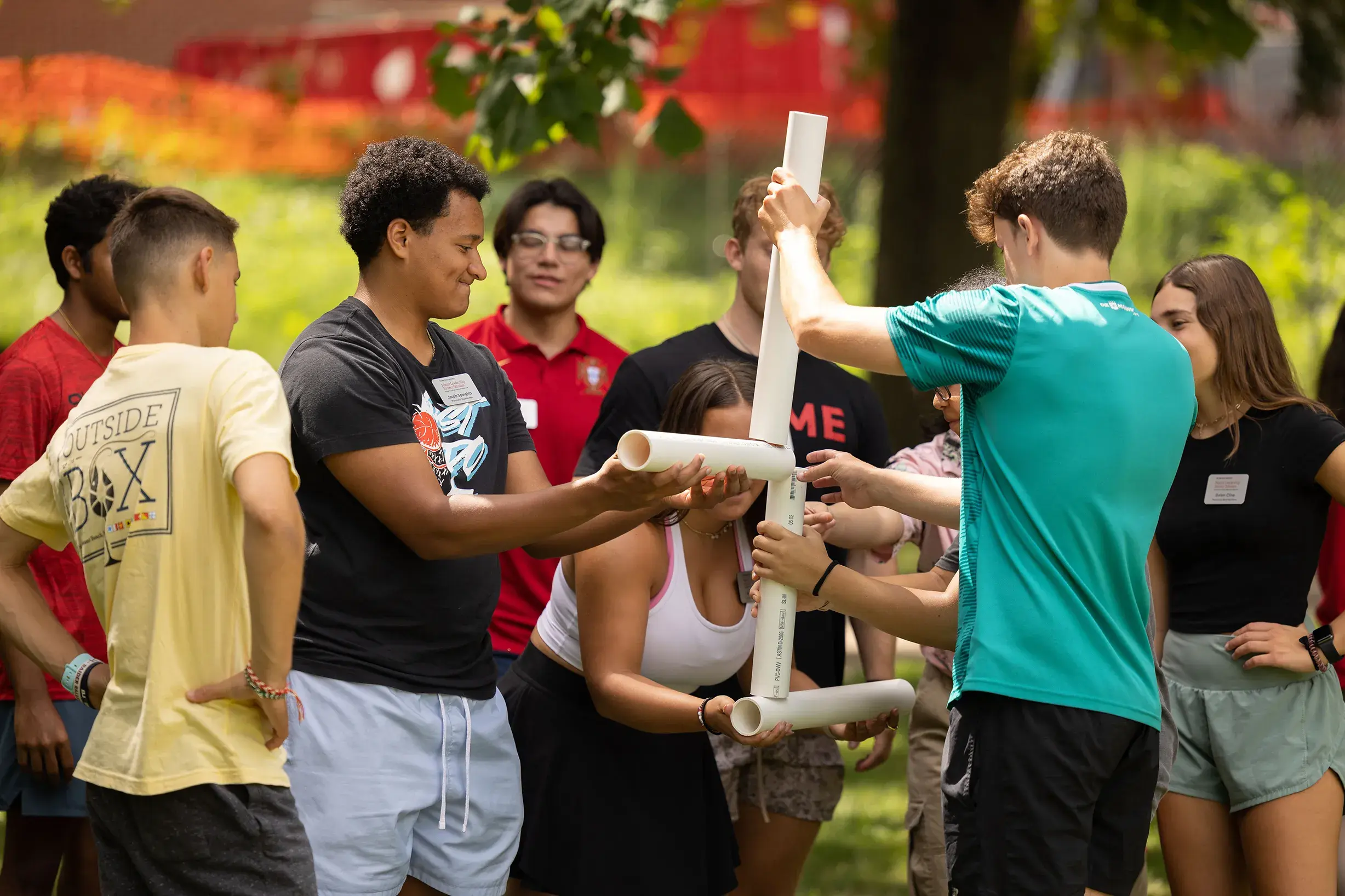 a group of ohio state students using pvc pipe to create a structure