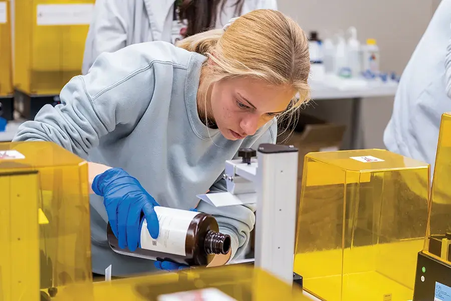 A female student works in a dental lab