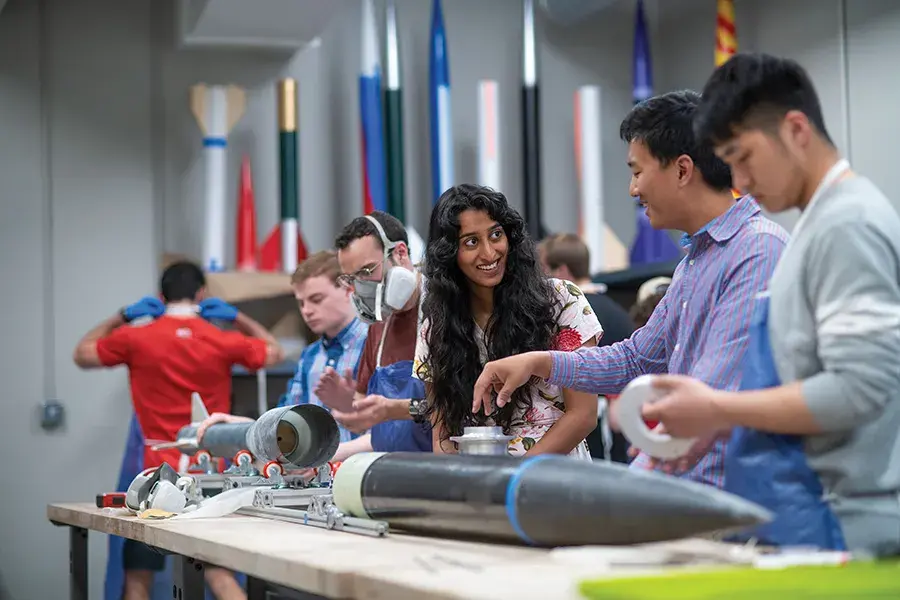 Many students stand in a research lab