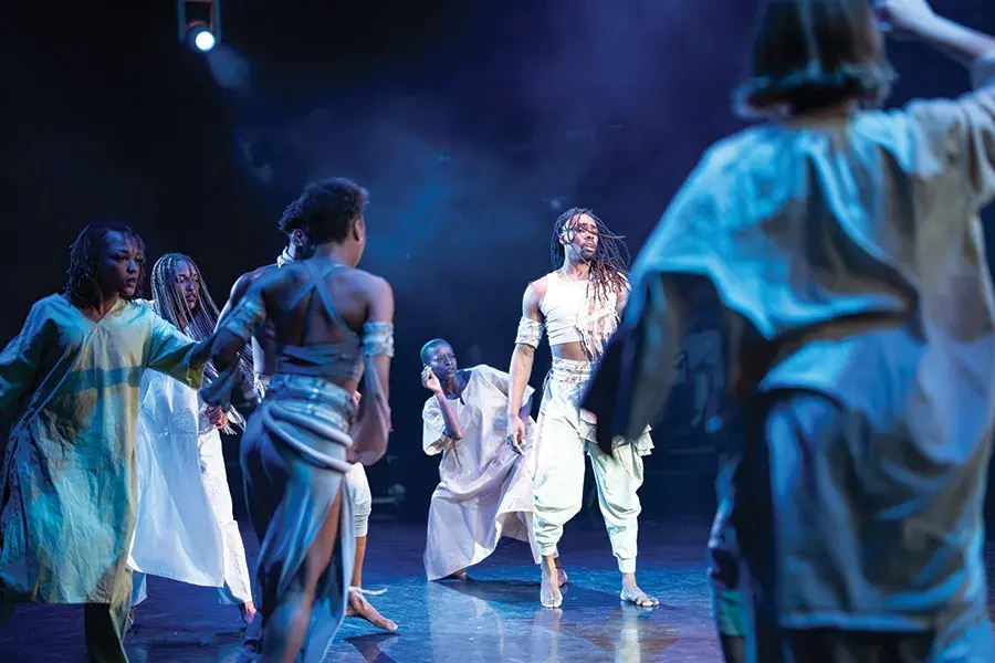 A group of dancers are on stage performing