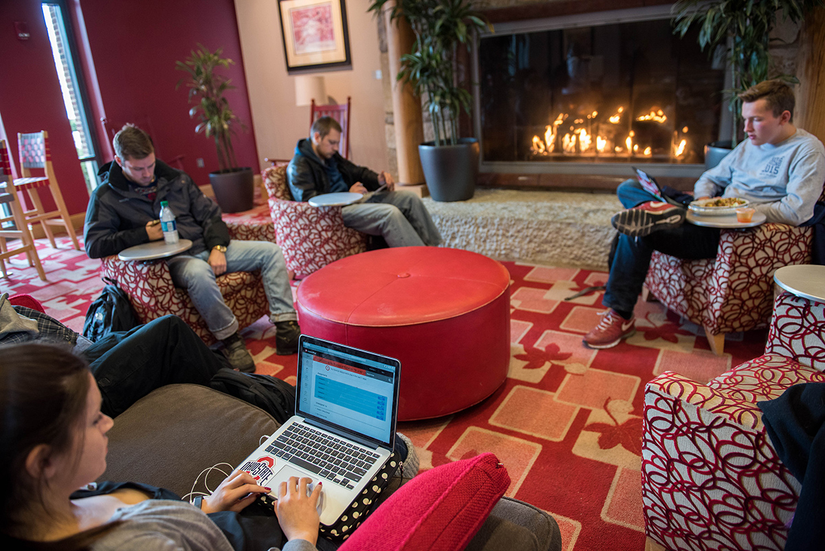 Four students studying in front of a fireplace in the Ohio Union.