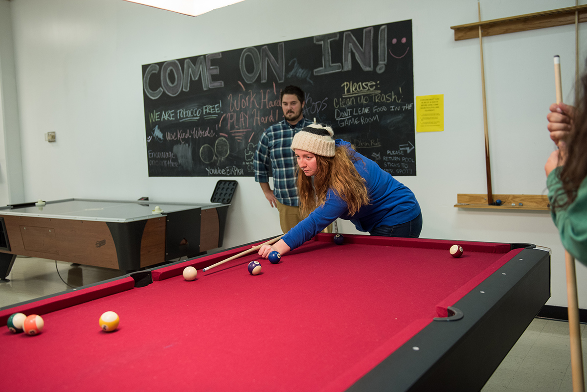 A student shoots pool while another looks on at the Eisenhower Student Union on the Ohio State Mansfield campus.