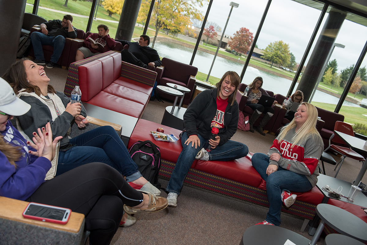 Three students sitting on couches laugh together at the Alber Student Center at Ohio State Marion.