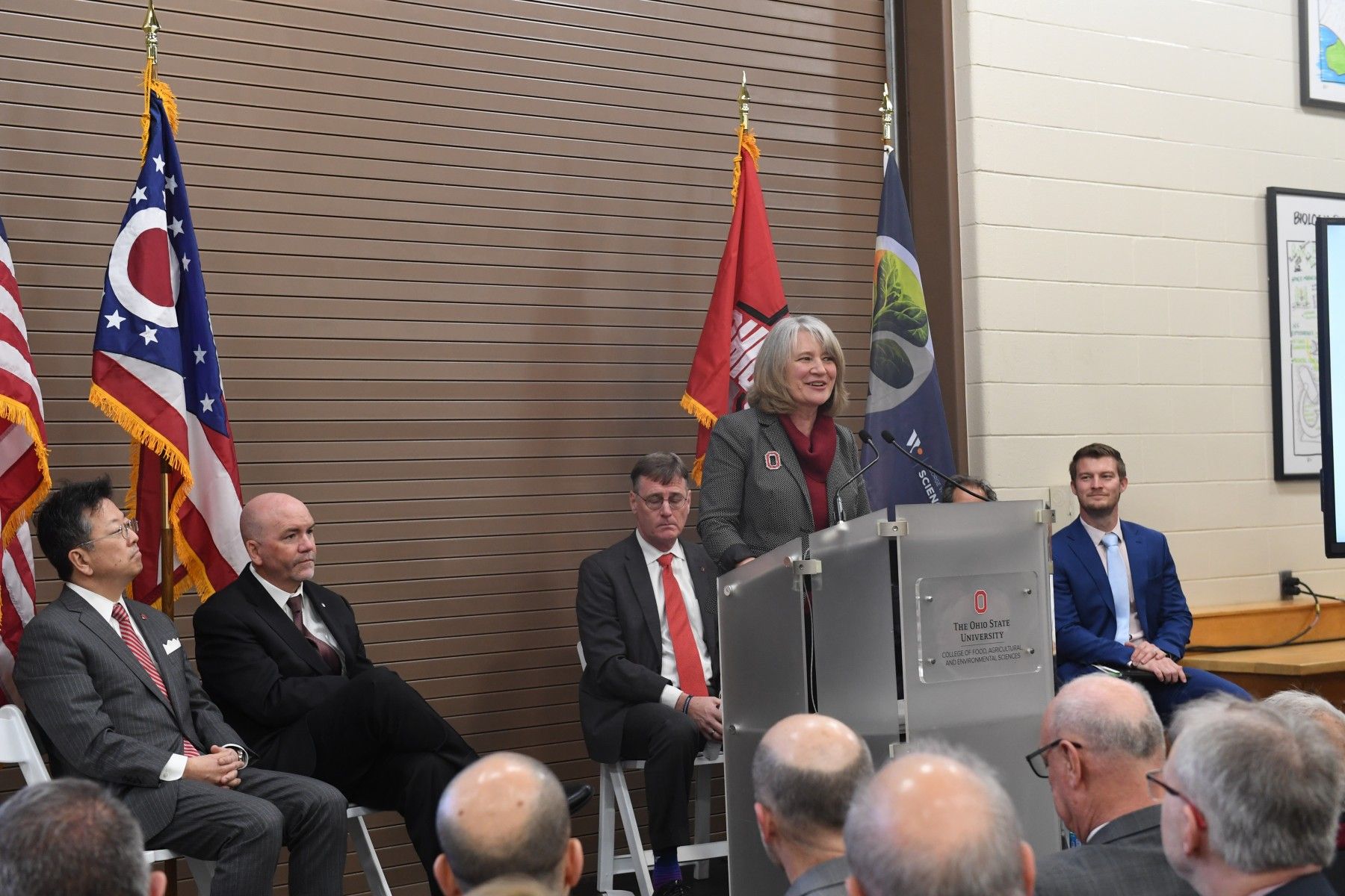 Cathann Kress, dean of the College of Food, Agricultural, and Environmental Sciences, addresses the grand opening audience with other officials behind her.