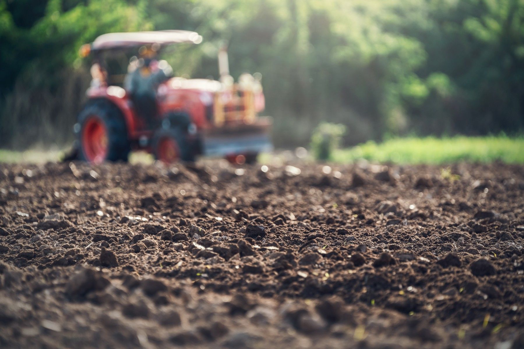 A field of soil with a tractor.