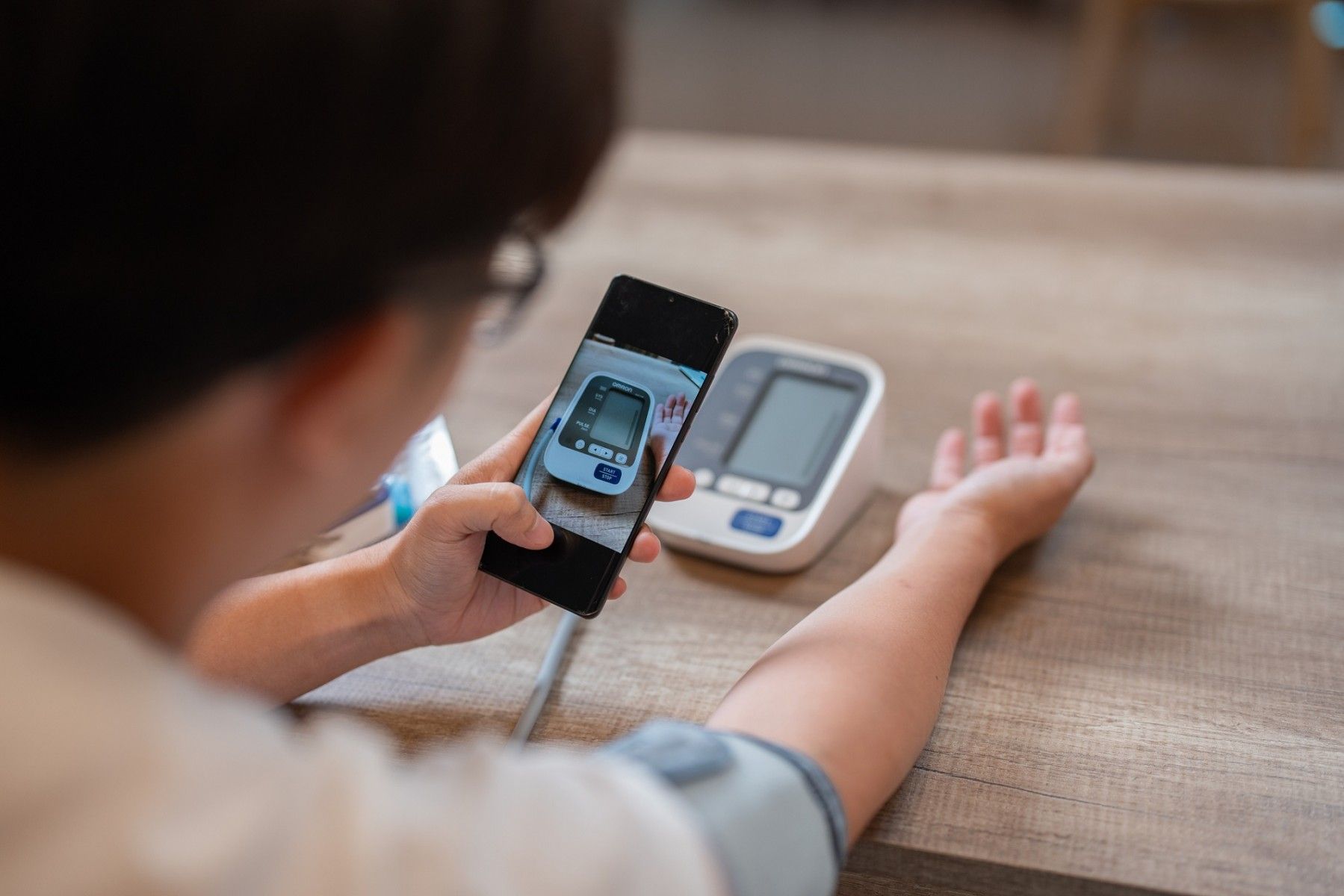 A patient uses a smartphone for telehealth services.