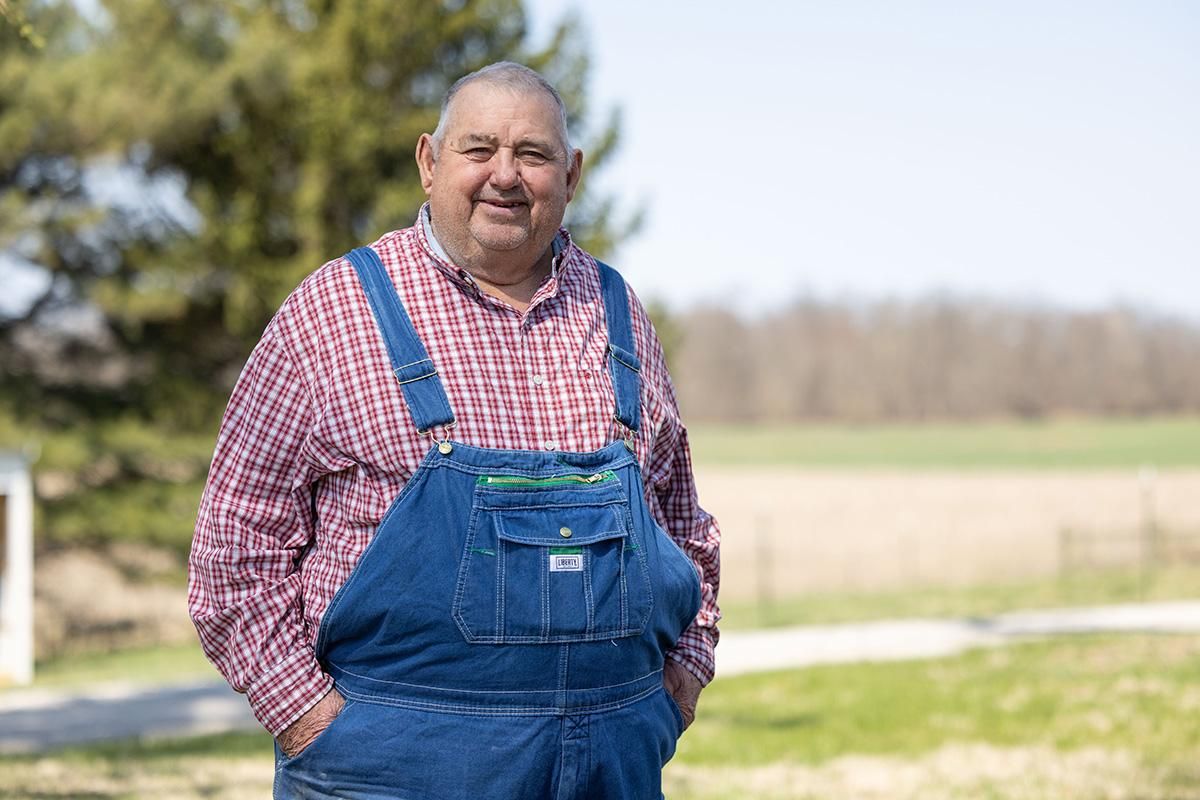 Headshot of Dave Brandt wearing a red plaid shirt and overalls