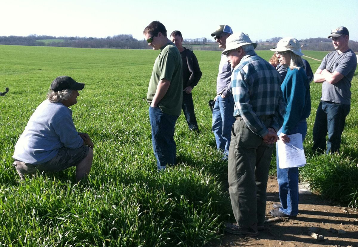 A farmer in a field speaks with fellow Ohioans