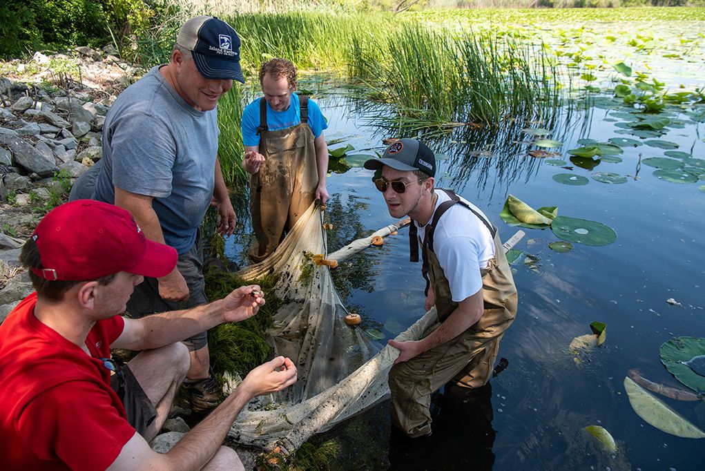 A student and Ohio State staff member work in Lake Erie