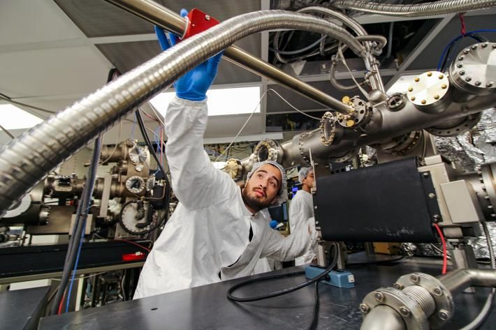 A student works on a piece of machinery