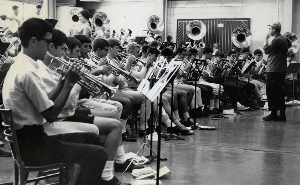 Black and white photo of marching band students practicing together