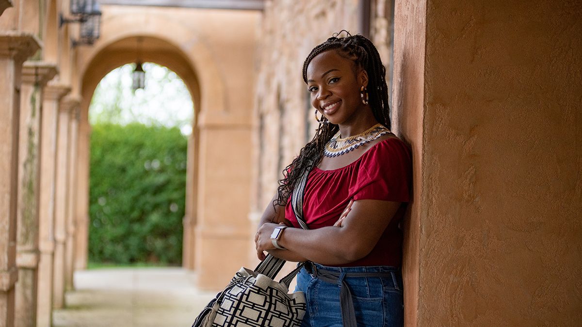 Ohio State alumna Amber Hammond leans against a wall in Columbus's Short North